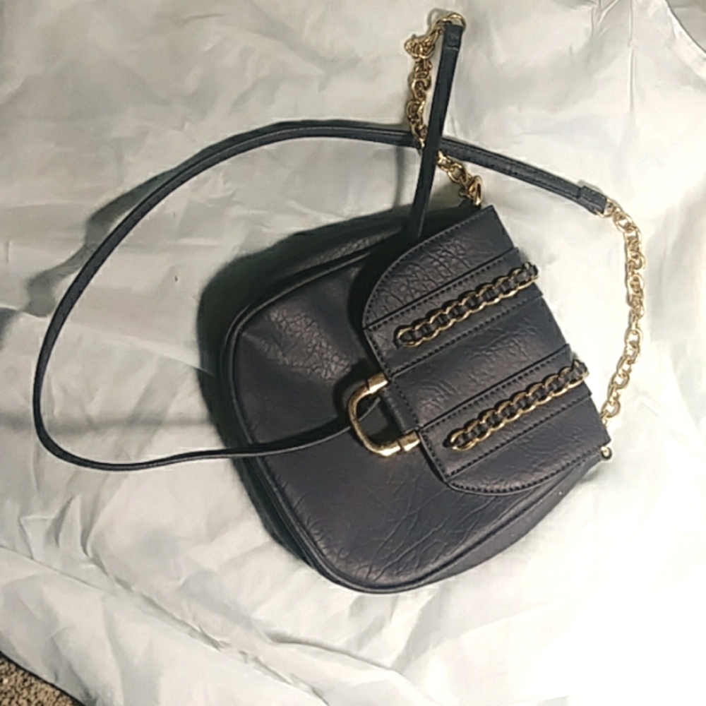 A cute navy blue charming charlie hand bag
